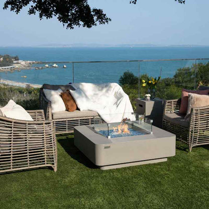 Elementi Plus Lucerne Fire Table with fame and windscreen near couch overlook balcony
